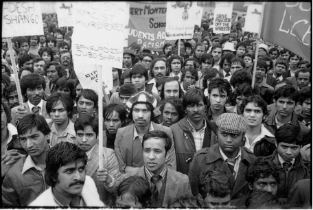 Photograph of a group of mostly Bengali men protesting in 1978, many of them holding signs.