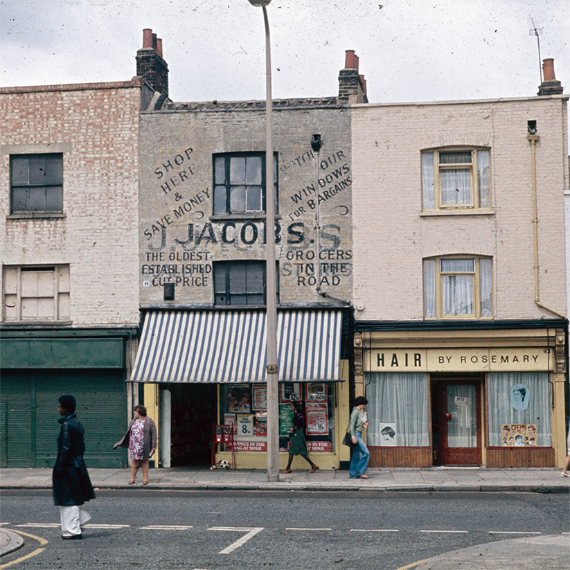 An old photograph of shop fronts on Roman Road