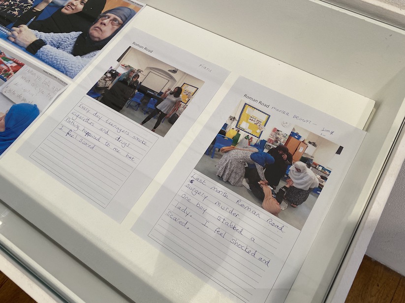 Papers with images of the women acting and captions underneath, in display boxes at Four Corners.